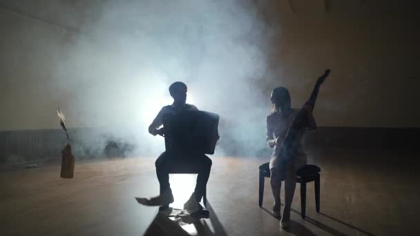 Musicians silhouettes playing and falling sheets, smoke on background in slowmo — Stock Video