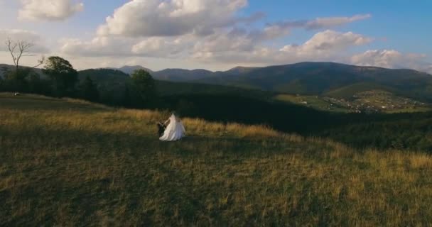 O casal em pé na pitoresca montanha no nascer do sol bckg 4k antena — Vídeo de Stock