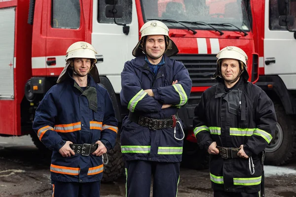 İtfaiyeci (itfaiye) eylem daimi bir firetruck yakınındaki. Acil durum Emanet. Koruma, tehlikeden kurtarmak.