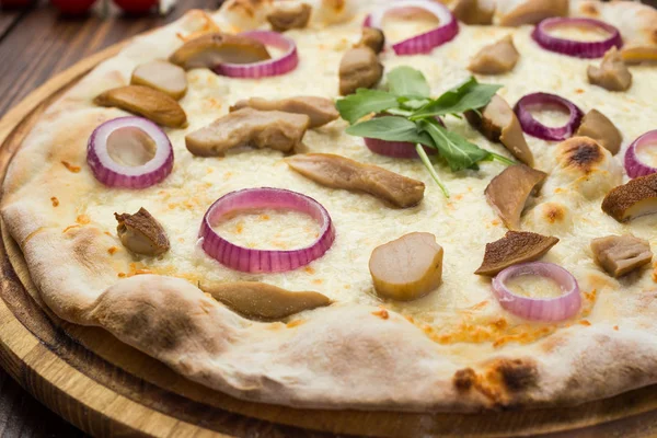 Pizza with mushrooms, mozzarella cheese and onion on wooden background