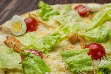 Pizza Sezar tavuk ve ahşap arka plan domates