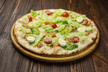 Pizza Sezar tavuk ve ahşap arka plan domates