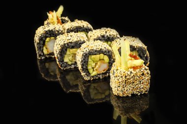 Koyu arka plan üzerinde siyah suşi roll ile karides ve avokado. Japon yemekleri