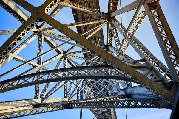 View of the historic city of Porto, Portugal with the Dom Luiz bridge. A metro train can be seen on the bridge
