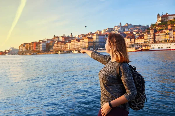 Güzel manzara eski şehir (Ribeira tarihi üç ay) ve nehir Duoro gün batımı sırasında Portekiz Porto şehir içinde manzarayı genç kadın turist