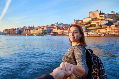 Güzel manzara eski şehir (Ribeira tarihi üç ay) ve nehir Duoro gün batımı sırasında Portekiz Porto şehir içinde manzarayı genç kadın turist. Beni kavramı takip