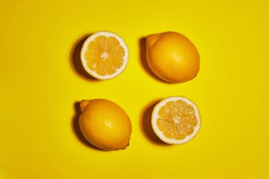 Lemon on yellow background. Flat lay, top view, copy space . Food concept. clipart