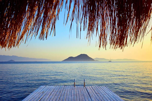 Bungalow am Meer bei Sonnenuntergang. Holzpavillons am Ufer eines Sandstrandes - Bodrum, Truthahn — Stockfoto