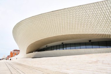 Lisbon, Portugal - 12 of December, 2018: Maat entrance, Museum of Art, Architecture and Technology, Amanda Levete, outward looking with organic curvy shapes. clipart
