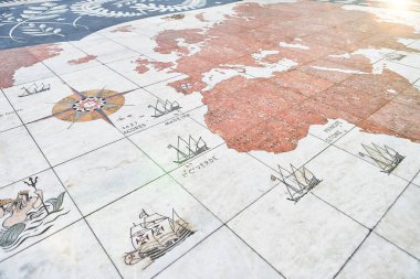 LISBON, PORTUGAL - 12 December 2018: Compass rose in Lisbon with world map showing Portuguese discoveries. Detail of the mosaic in front of the 