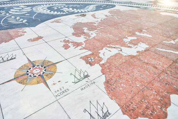 LISBON, PORTUGAL - 12 December 2018: Compass rose in Lisbon with world map showing Portuguese discoveries. Detail of the mosaic in front of the "Padrao dos Descobrimentos"