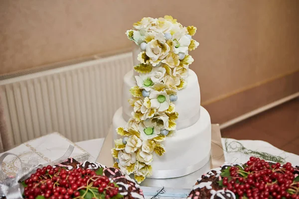 wedding festive multi-storey cake in white tone decorated with beautiful flowers