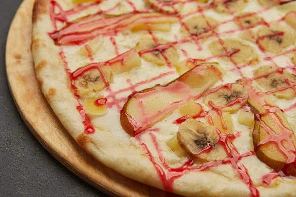 Sweet pizza with bananas and pear