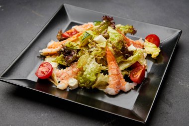 Taze deniz ürünleri salatası karideslerle servis edilir. )