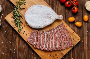 Geleneksel kurutulmuş salam sosisi, otlu ve kiraz domatesli köy ahşabı.