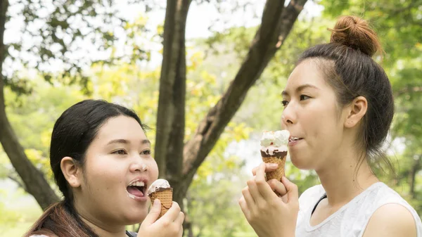 two people fat and cute girl eat ice cream with feeling delicious