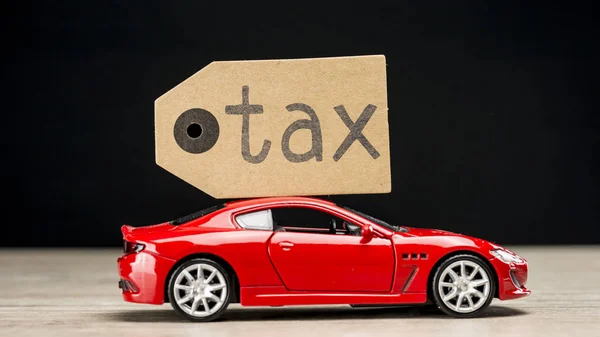 Red car with tag writing tax