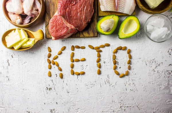 Ketogenic diet food. Balanced low-carb food background. Fish, meat, cheese, nuts on a white background. Healthy balanced food with high content of healthy fats. Diet for the heart and blood vessels.