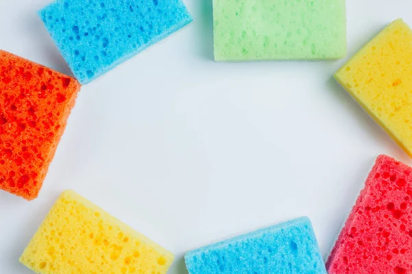 Brightly colored sponges on white background