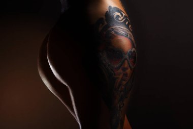 closeup female ass with tattoo
