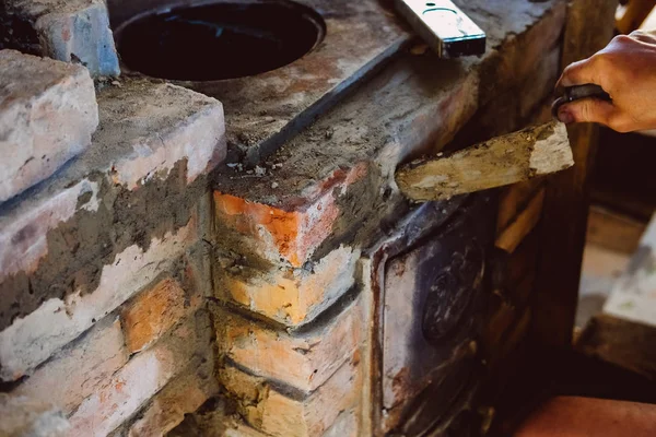 Restoration repair of the old village furnace. Bricklaying.