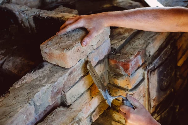 Restoration repair of the old village furnace. Bricklaying.