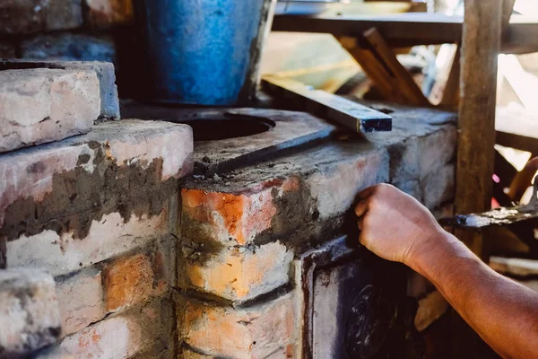 Restoration repair of the old village furnace. Bricklaying.