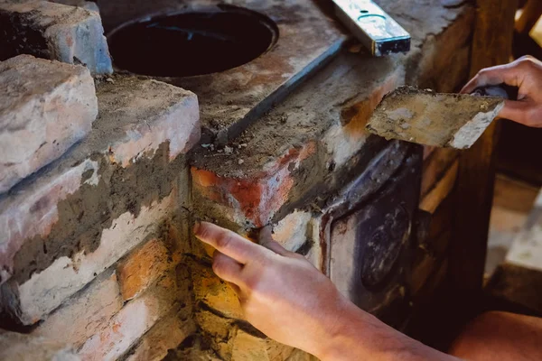 Restoration repair of the old village furnace. Bricklaying.