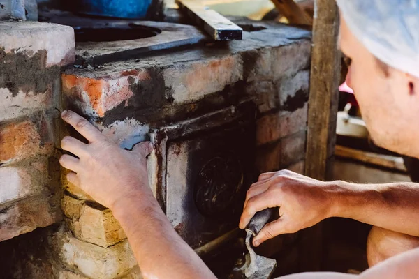 Restoration repair of the old village furnace. Bricklaying.