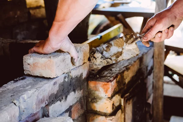 Restoration repair of the old village furnace. Bricklaying.