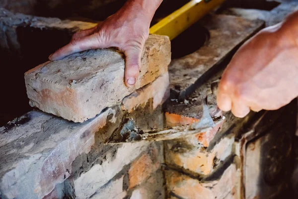 Restoration repair of the old village furnace. Bricklaying.