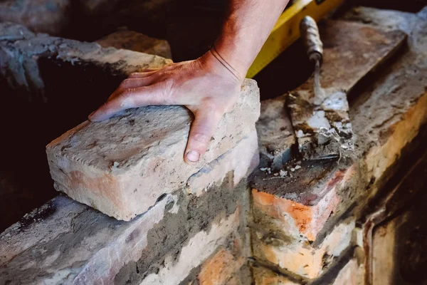 Restoration repair of the old village furnace. Bricklaying.