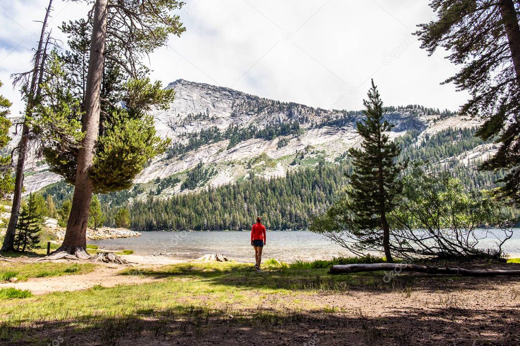 A woman observes a lake, Yosemite National Park, in California