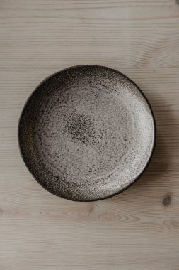 Dekoratif kil plaka, kopyalama alanı olan bir ahşap zemin üzerinde.