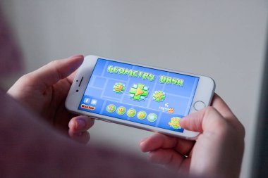 Los Angeles, Kaliforniya, ABD - 8 Mart 2019: a smartphone ile geometri Dash oyunu göstermek perde, açıklayıcı yayın holding eller