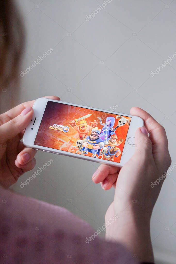 Los Angeles, California, USA - 8 March 2019: Hands holding a smartphone with Clash Royale game on screen, Illustrative Editorial