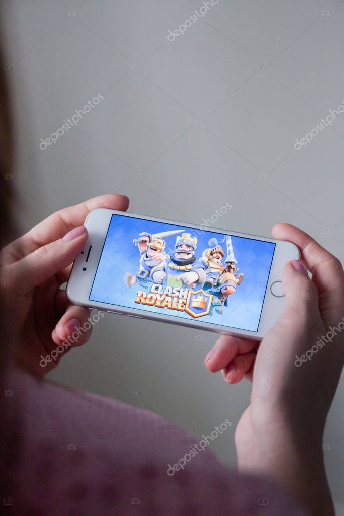 Los Angeles, California, USA - 8 March 2019: Hands holding a smartphone with Clash Royale game on screen, Illustrative Editorial