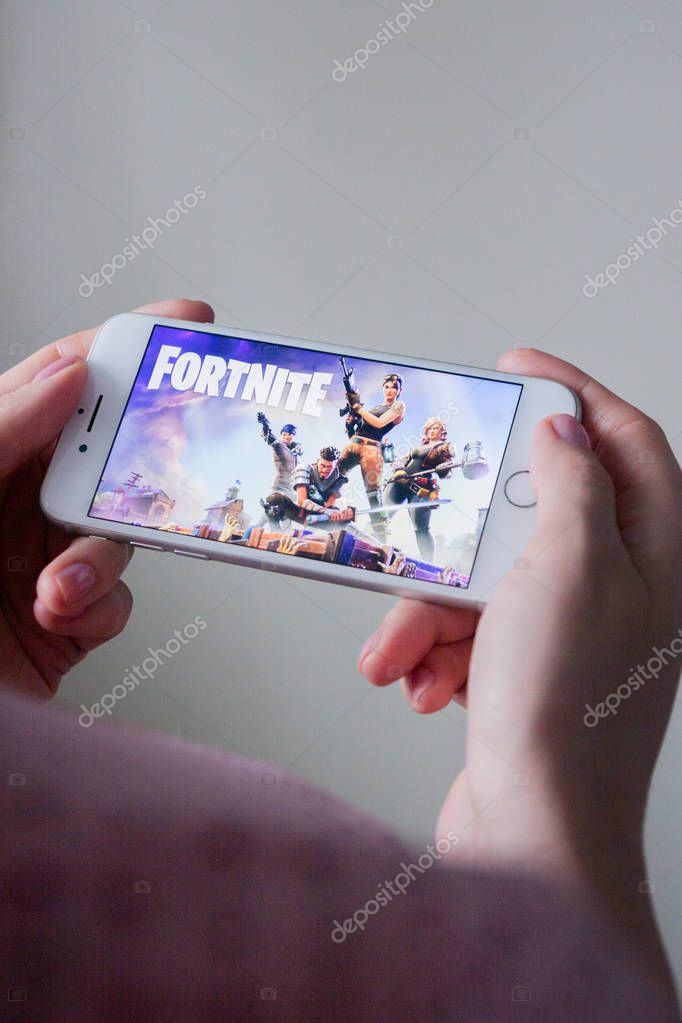 Los Angeles, California, USA - 8 March 2019: Hands holding a smartphone with Fortnite game on screen, Illustrative Editorial