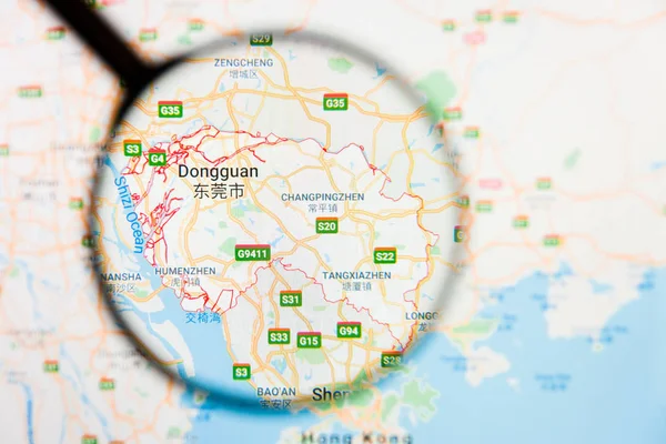 Dongguan, China city visualization illustrative concept on display screen through magnifying glass