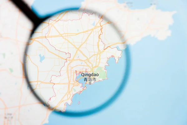 Qingdao, China city visualization illustrative concept on display screen through magnifying glass — Stock Photo, Image