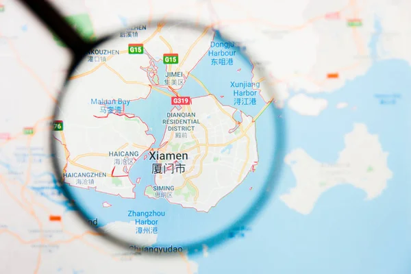 Xiamen, China city visualization illustrative concept on display screen through magnifying glass