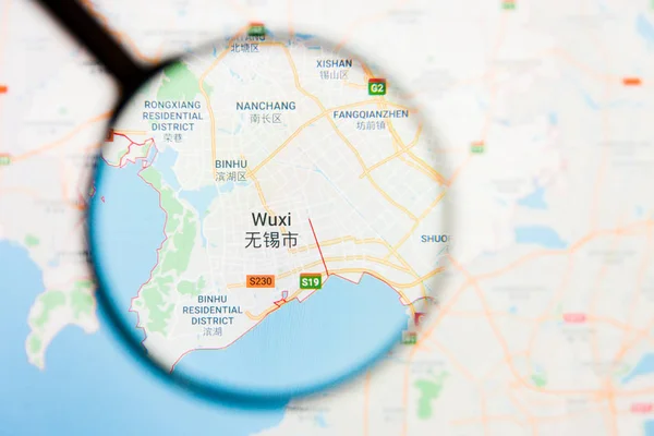 Wuxi, China city visualization illustrative concept on display screen through magnifying glass — Stock Photo, Image