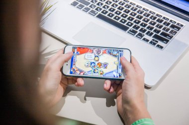 Los Angeles, Kaliforniya, ABD - 25 Şubat 2019: Hearthstone oyununun olduğu akıllı telefonu ekranda tutan eller