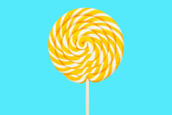 Yellow Twisted Lollipop Blue Background — Stock Photo, Image