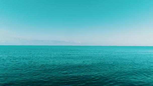 Flying over the deep, undulating sea at dawn. The vast blue water and the horizon. Aerial view of the Quiet Sea. — Stock Video