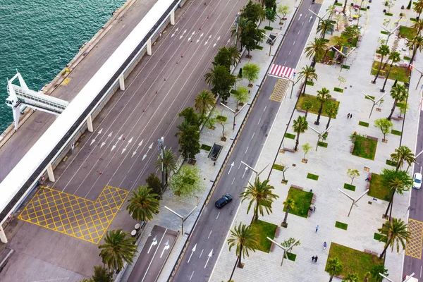 Barcelona, Catalonia. View from above. Road near Mediterranean sea and street with palm trees.