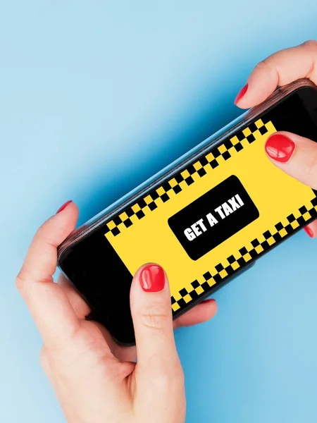 Woman hands holding a smartphone with mobile application order taxi service.