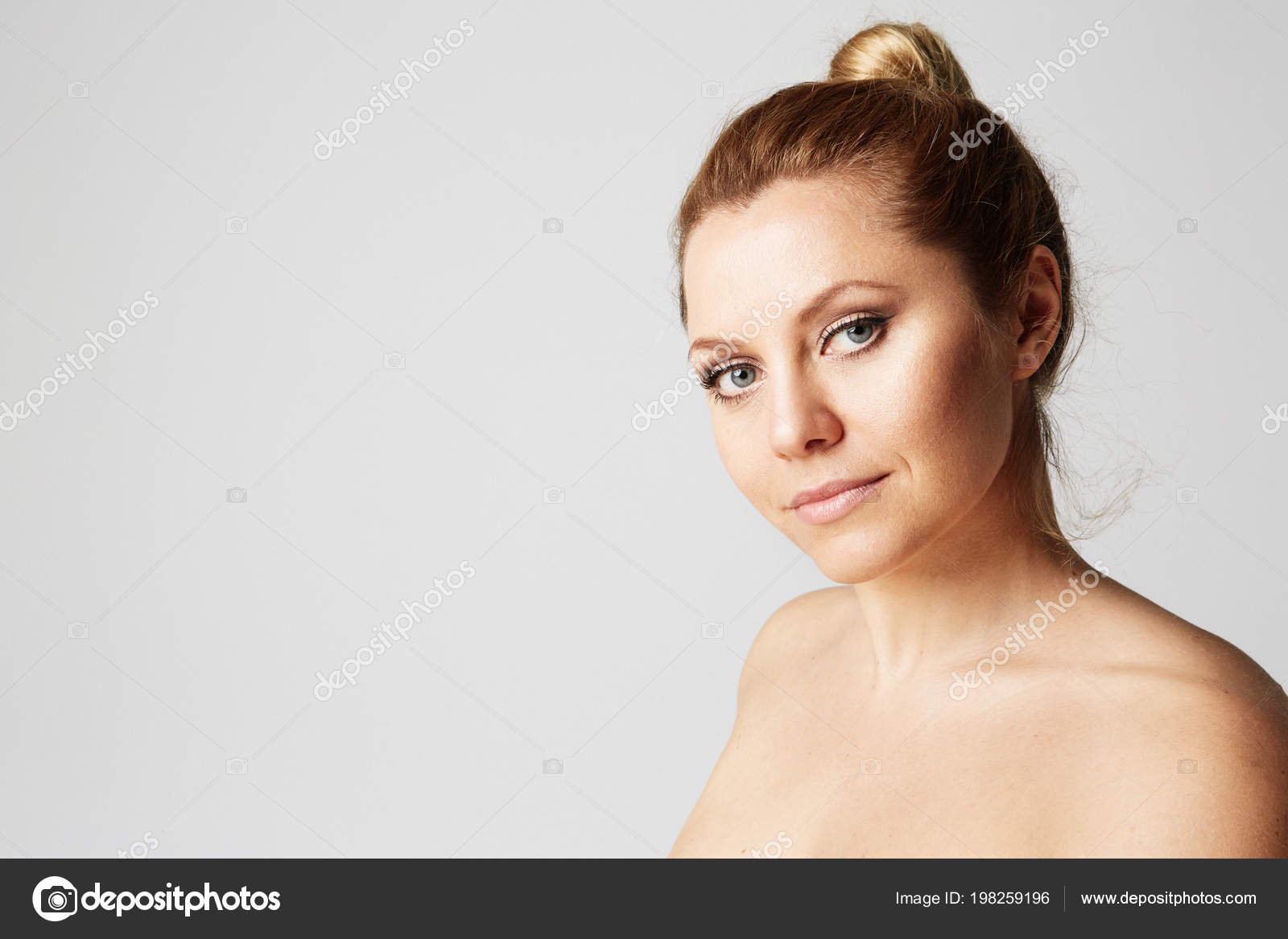 Young Beautiful Woman With Blonde Hair Fixed Behind Big Eyes
