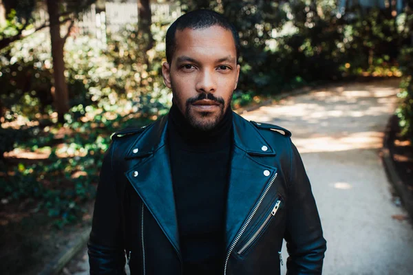 Confident stylish african american man wearing black leather jacket outdoor. Street wear fashion black man