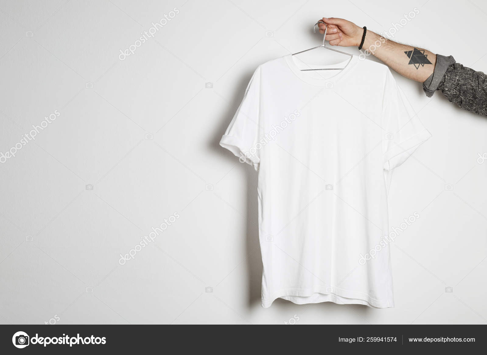 Download Tattooed Hipster Hand Holds Hang With Blank White T Shirt From Premium Thin Cotton On White Background Mockup Copy Paste Advertisement Stock Photo Image By C Eyecan 259941574